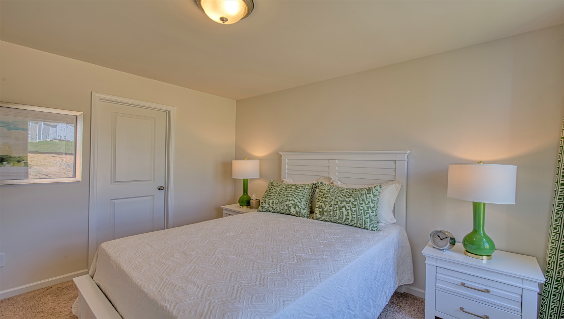 Carpeted bedroom with large window