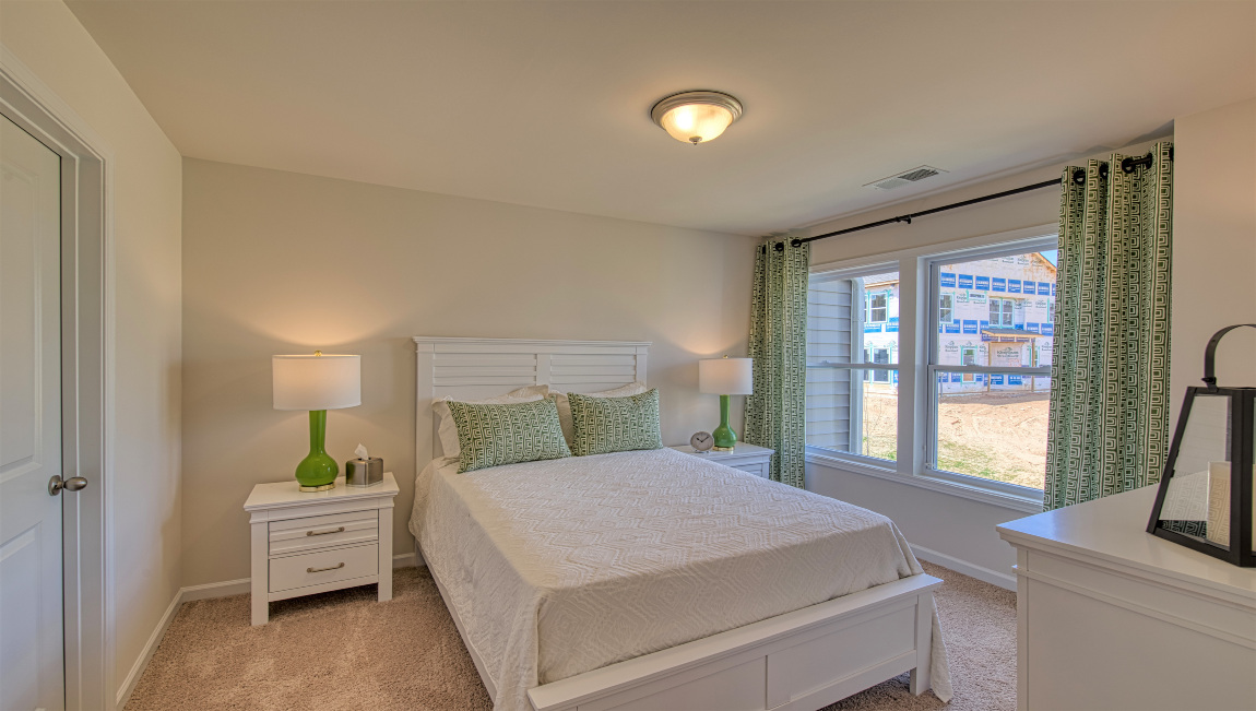 Carpeted bedroom with large window