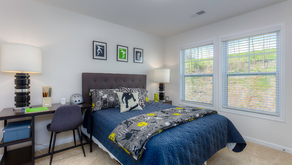 Carpeted bedroom with large window