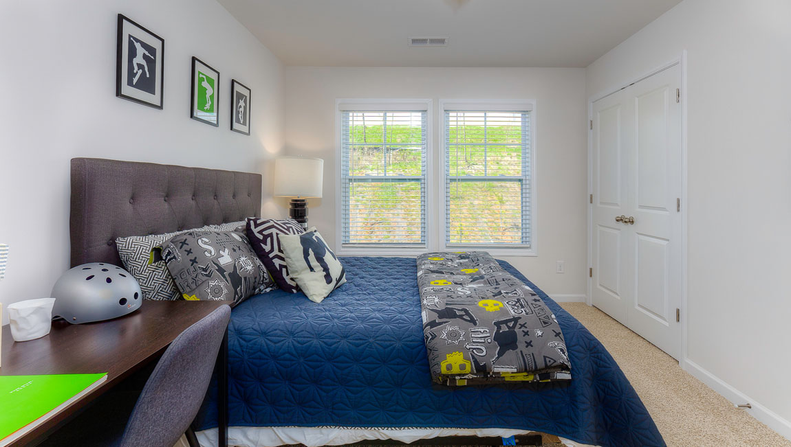 Carpeted bedroom with large window