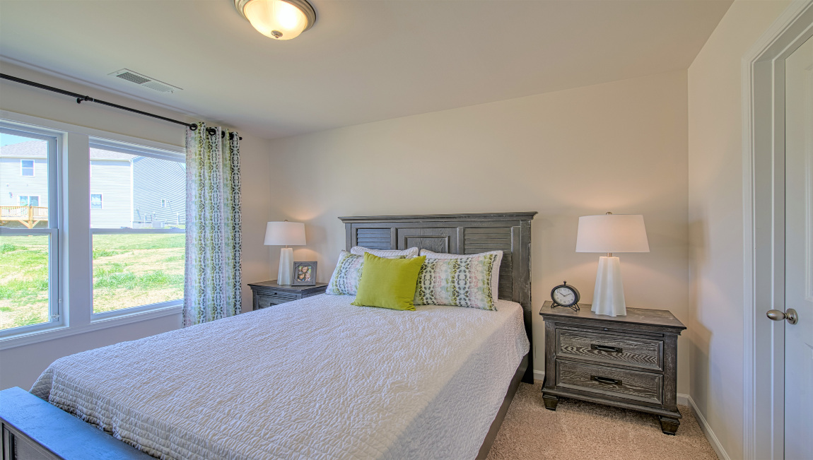 Carpeted bedroom with large window