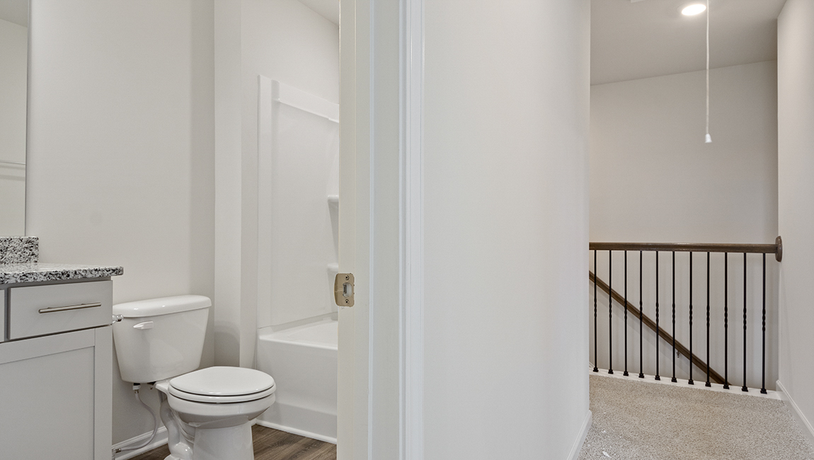 Upstairs hallway with glimpse of bathroom