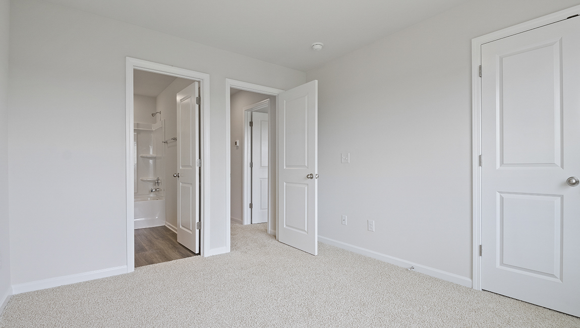Carpeted bedroom with large window
