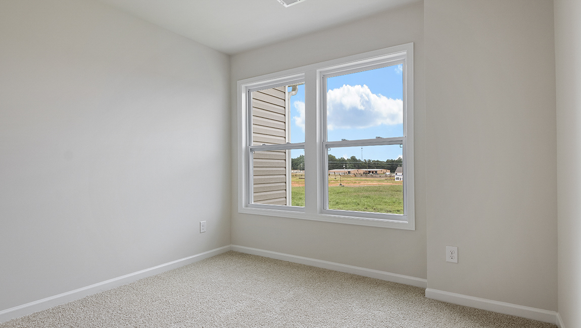 Carpeted bedroom with large window