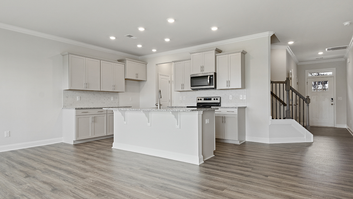 Kitchen and island with stainless steel appliances
