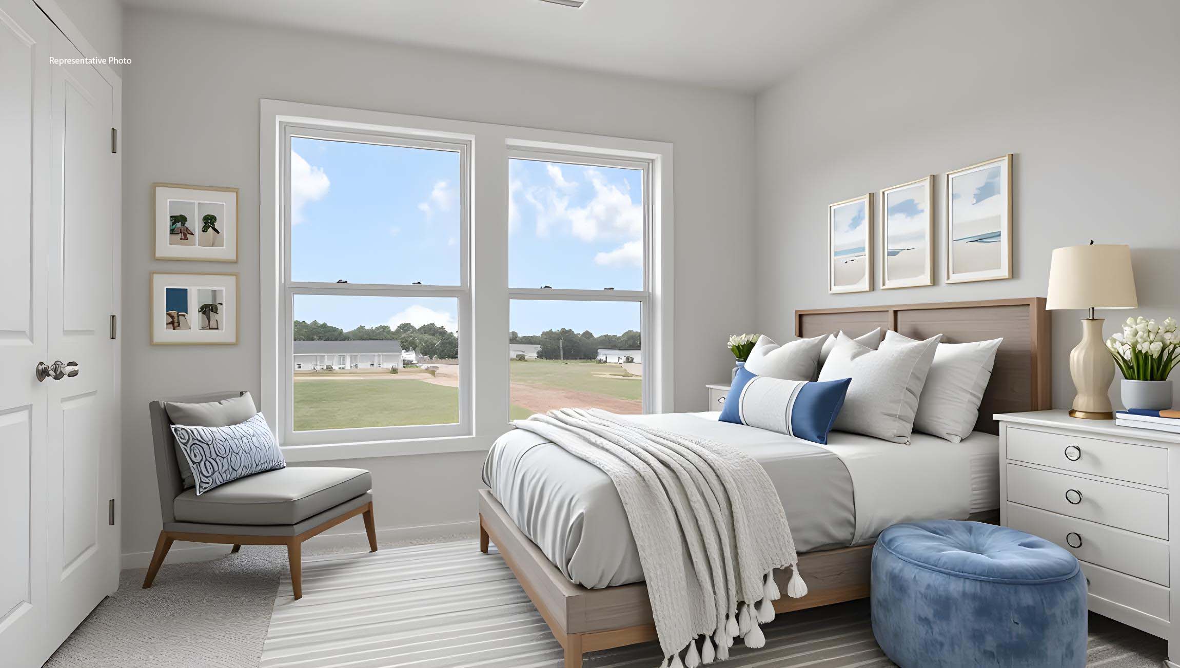 Carpeted bedroom with large window