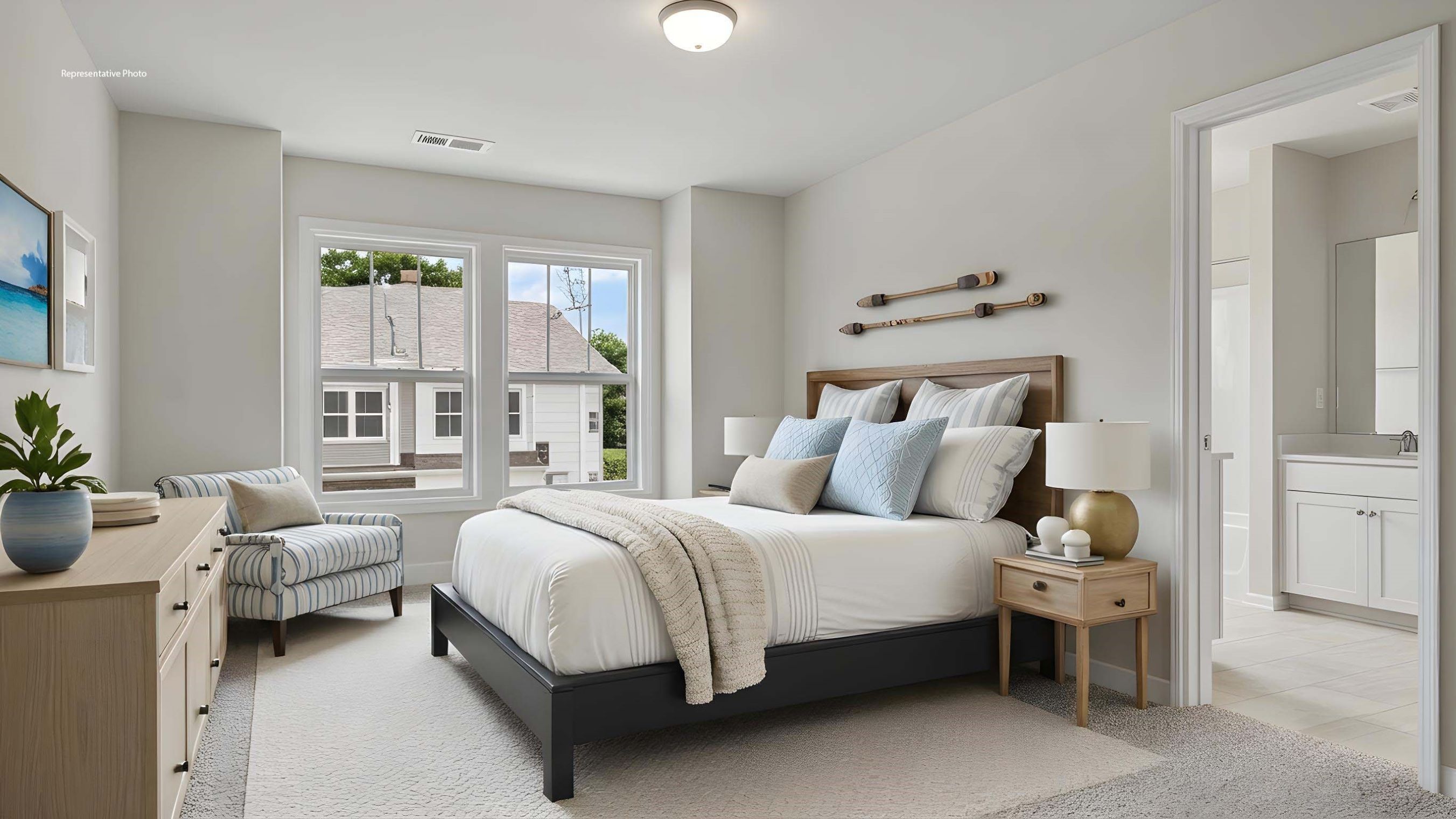 Primary carpeted bedroom with large window