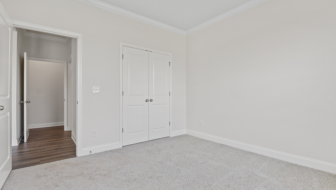 Carpeted bedroom with large window