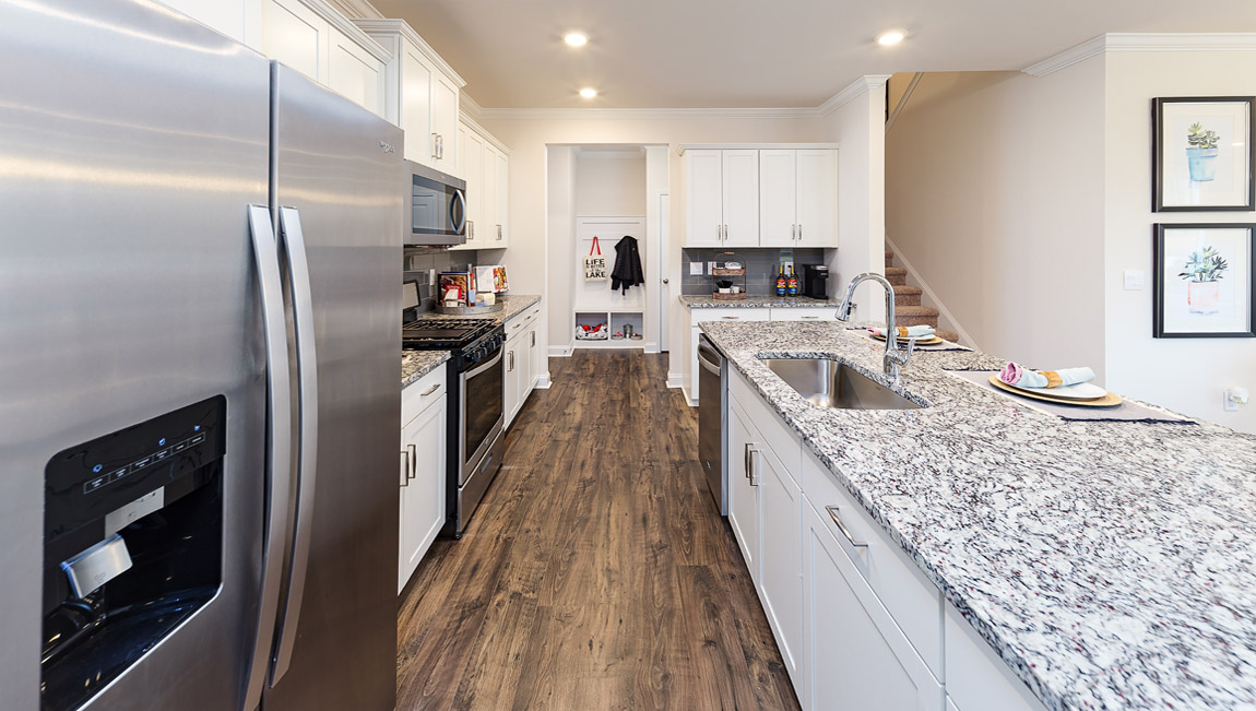 Kitchen and island with stainless steel appliances