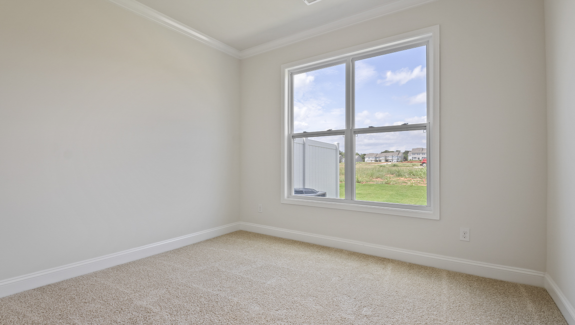 Carpeted bedroom with large window