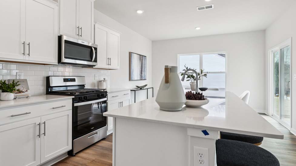 Kitchen and island with stainless steel appliances