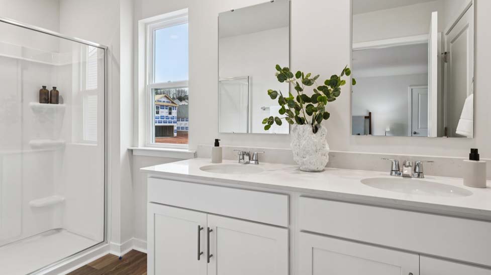 Primary bathroom with dual vanity and walk in shower