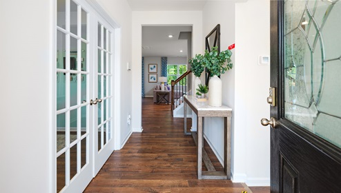 model welcoming foyer facing interior of home