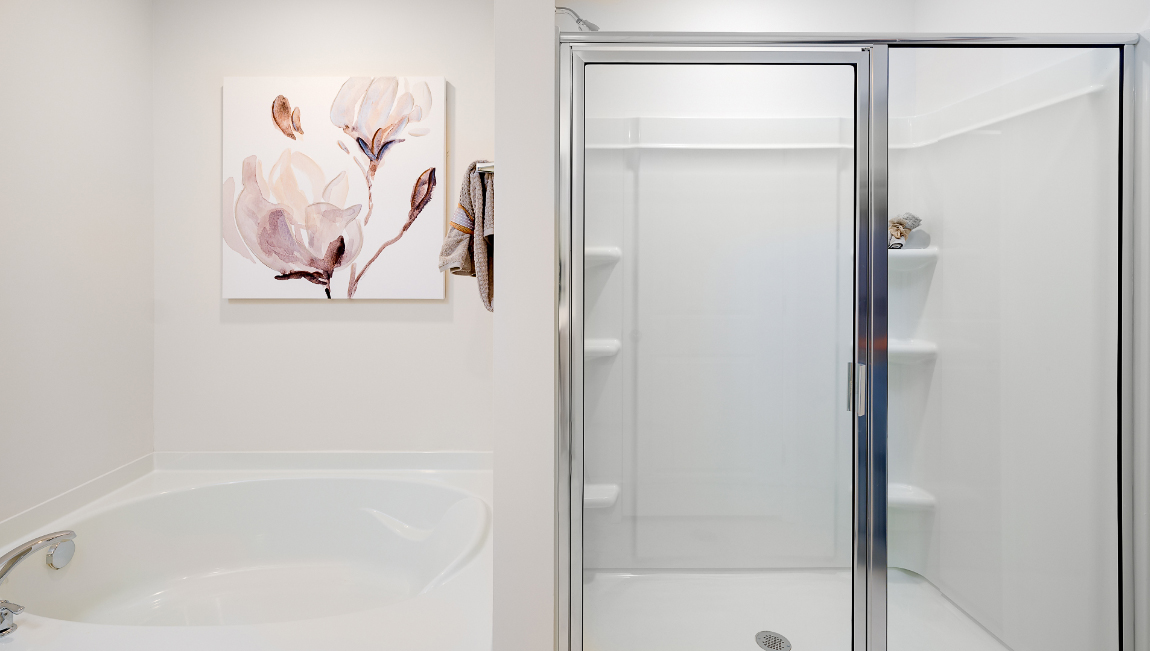 primary bathroom with dual vanity and walk in shower