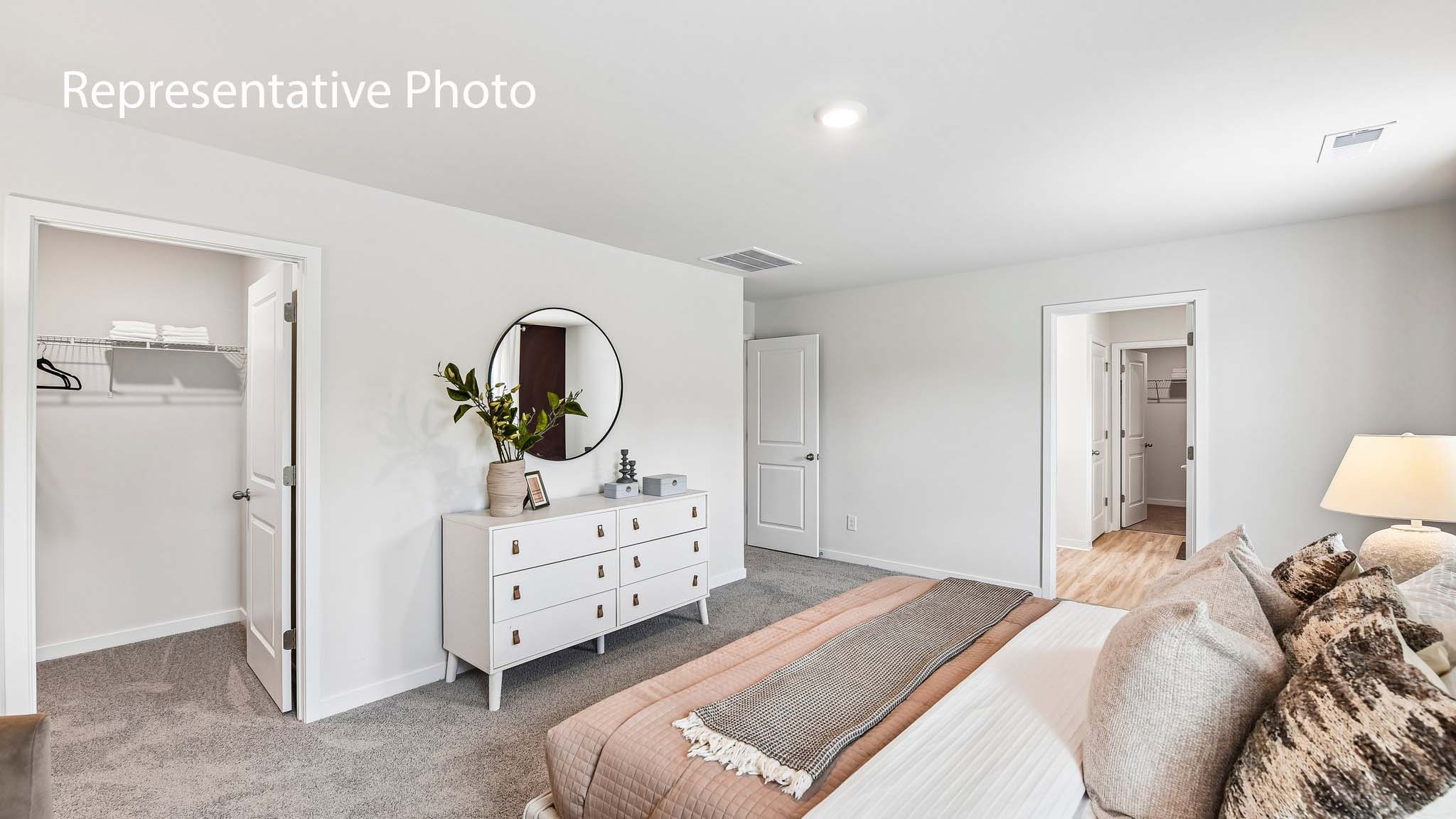primary carpeted bedroom with windows