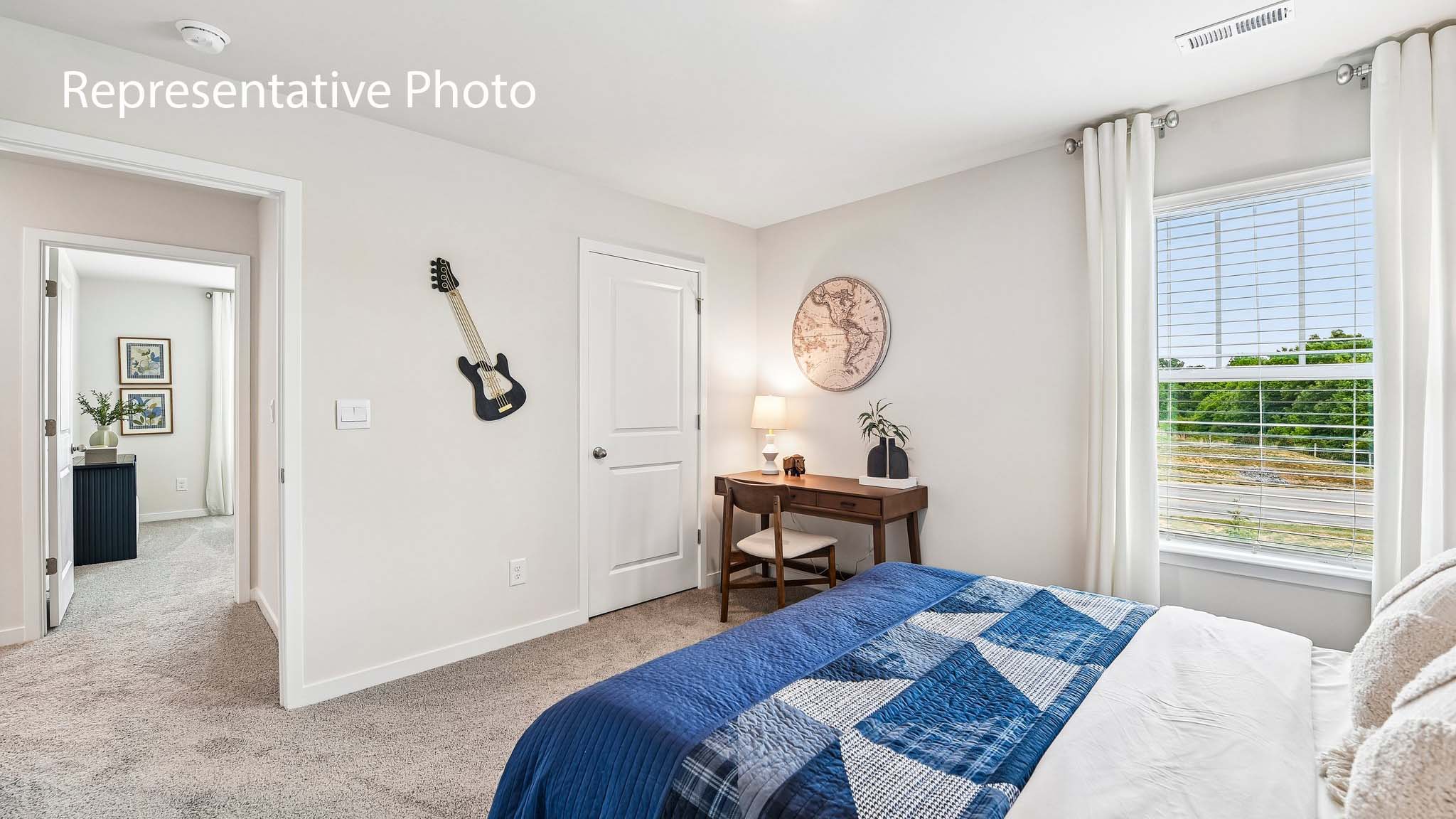 carpeted bedroom with large window