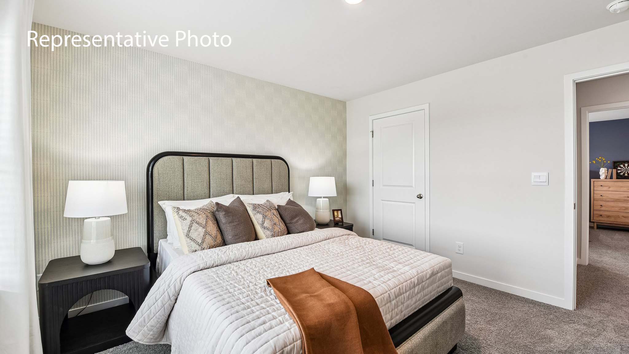 carpeted bedroom with large window