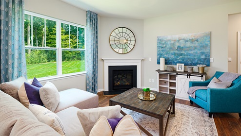 model open family room with windows and fireplace