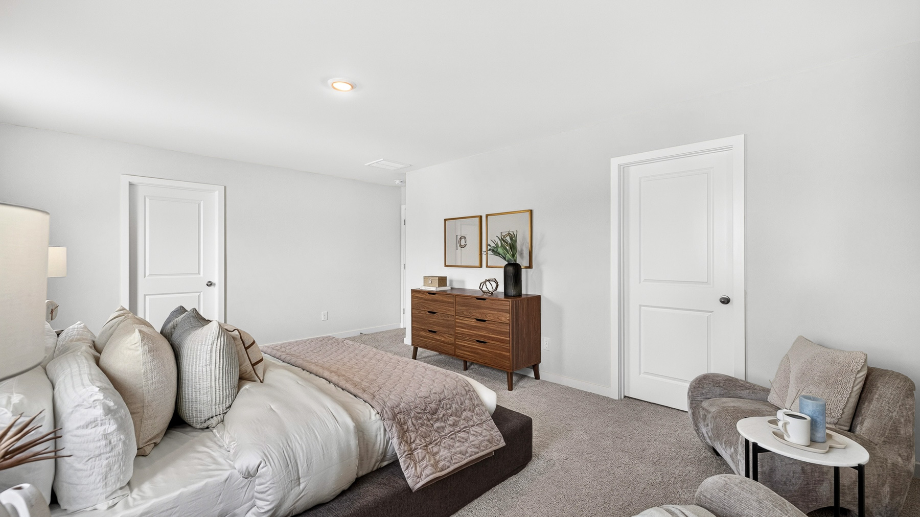 Primary carpeted bedroom with windows