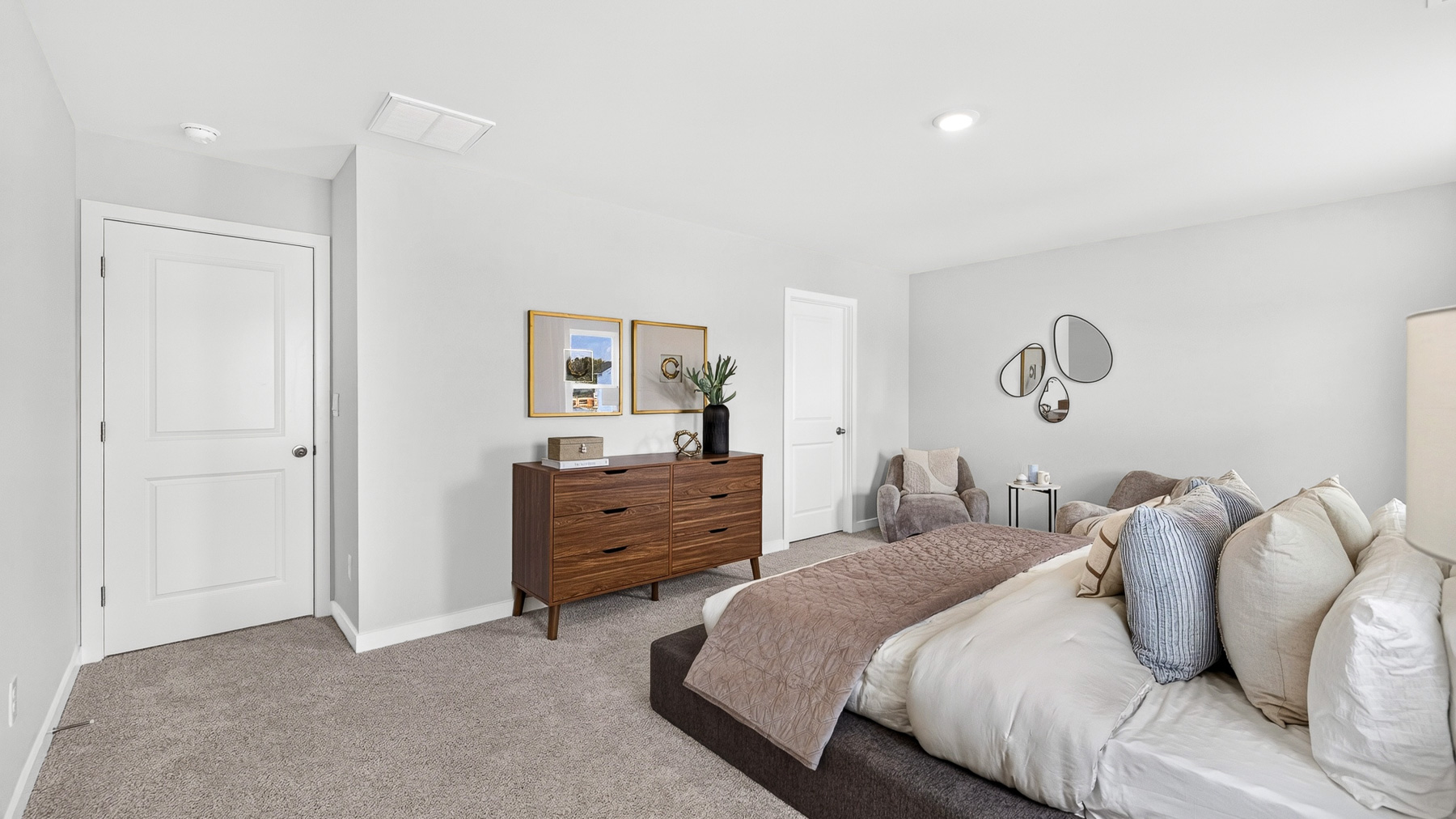 Primary carpeted bedroom with windows