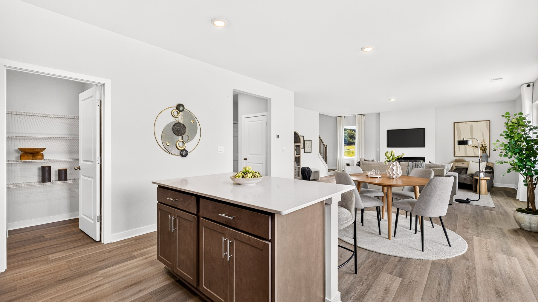 Kitchen and island with brown cabinets and stainless steel appliances