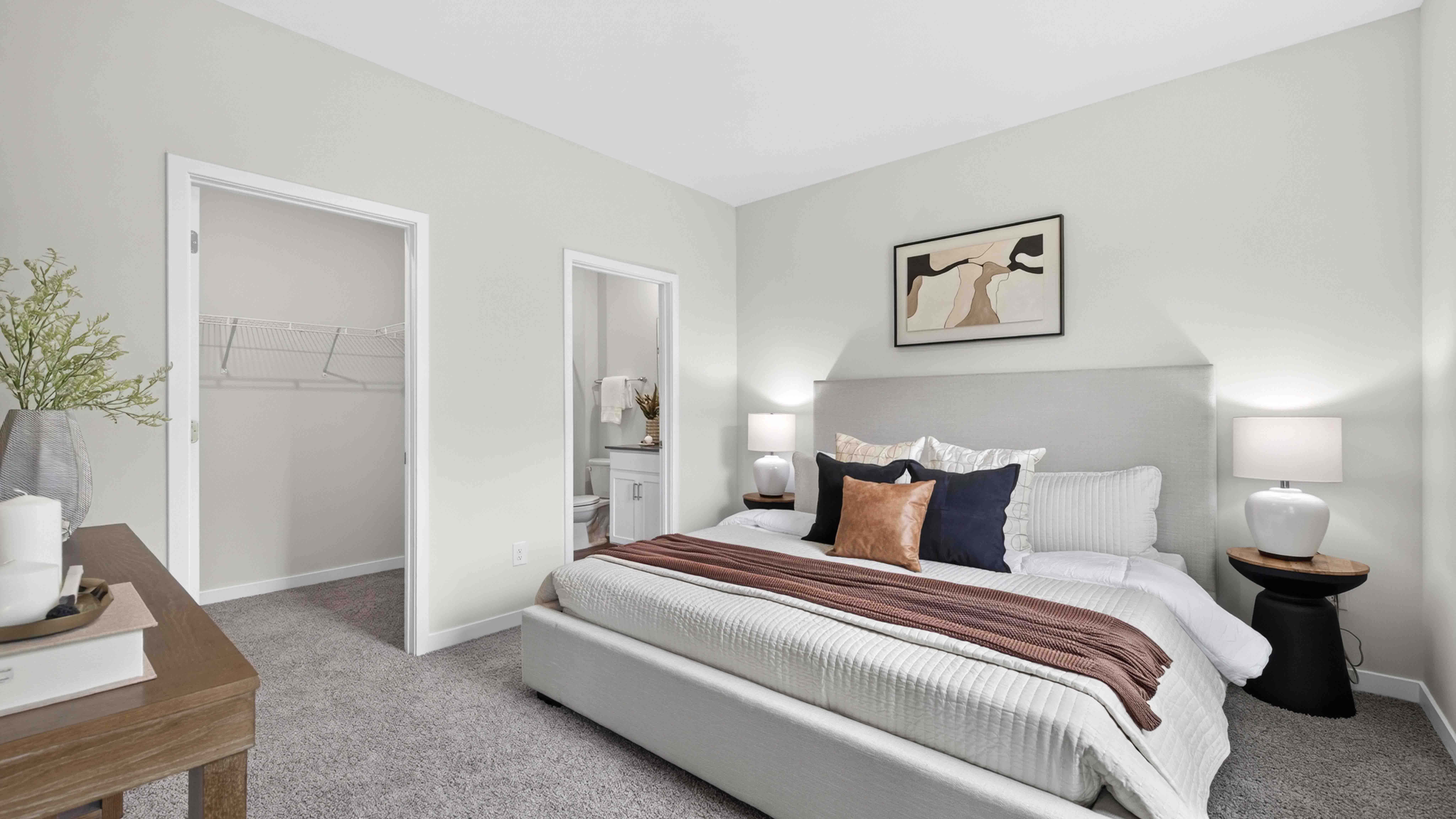 Primary carpeted bedroom with windows