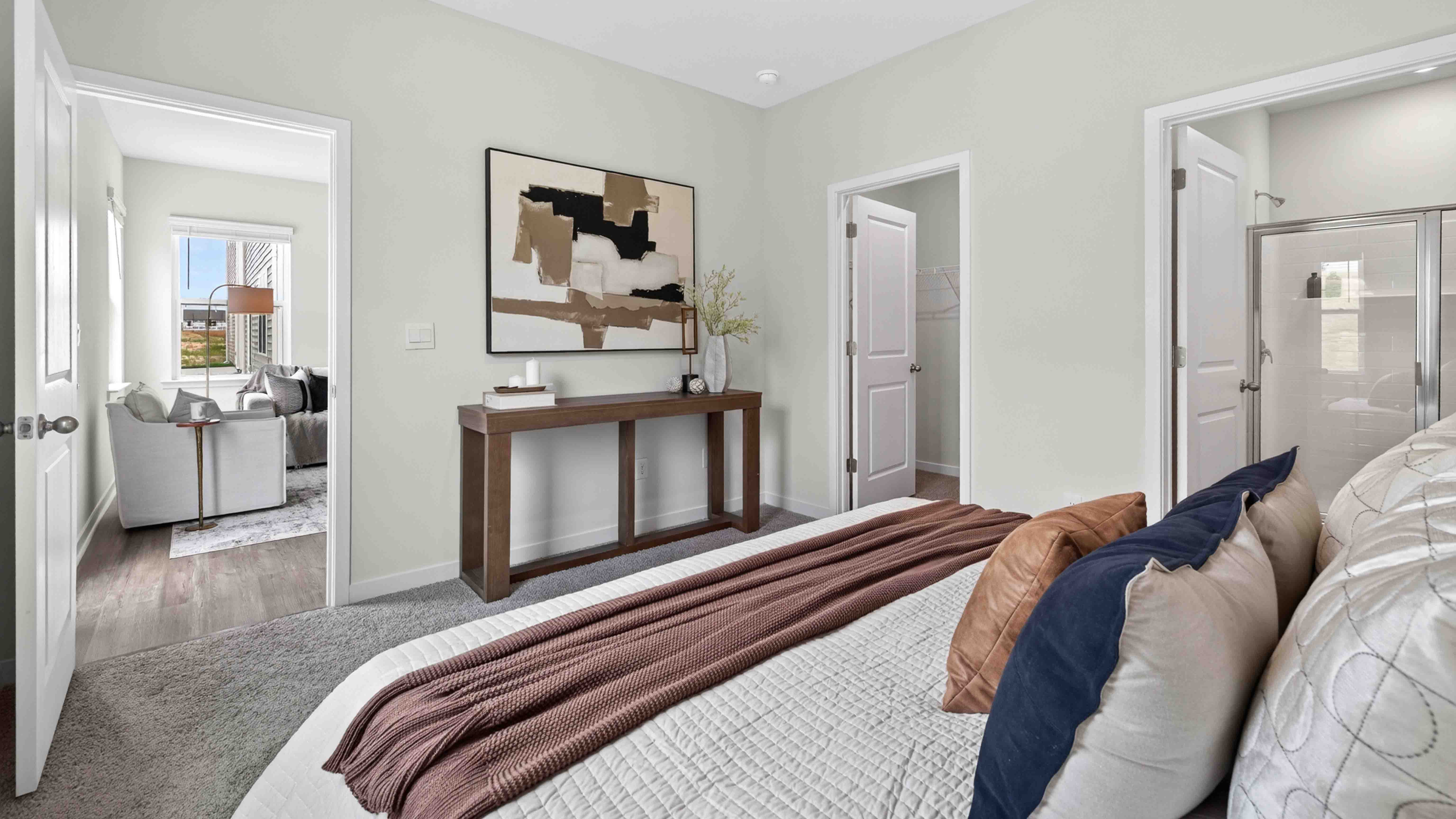 Primary carpeted bedroom with windows