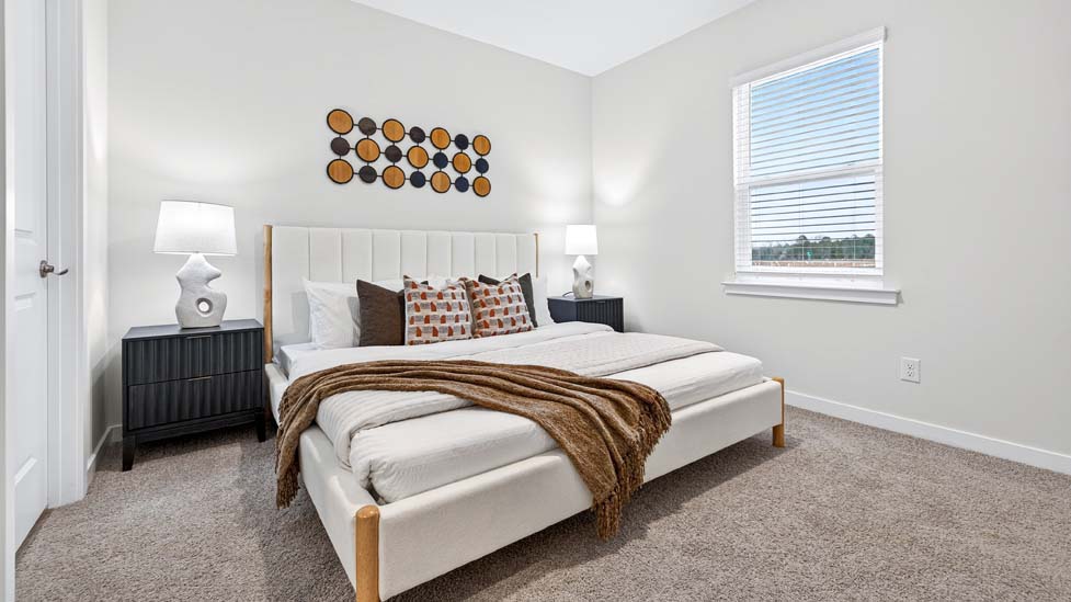 carpeted bedroom with large windows