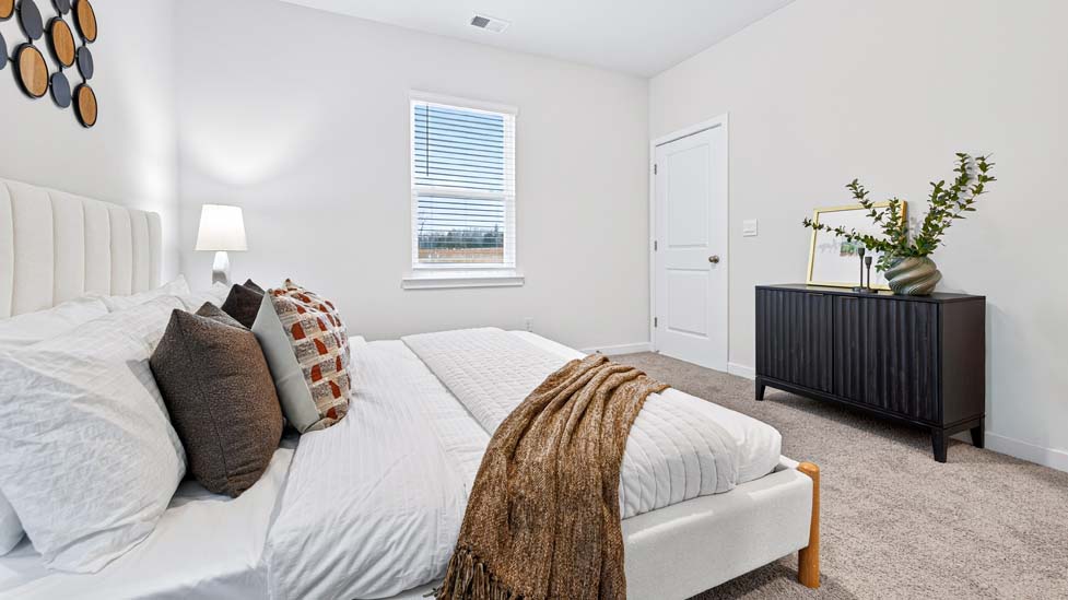 carpeted bedroom with large windows