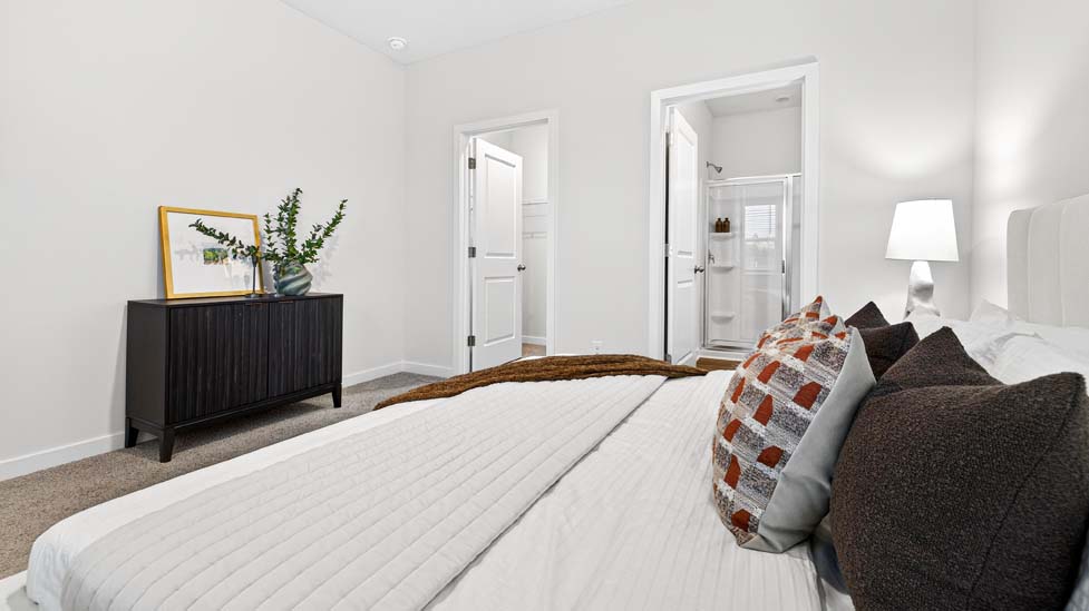 carpeted bedroom with large windows