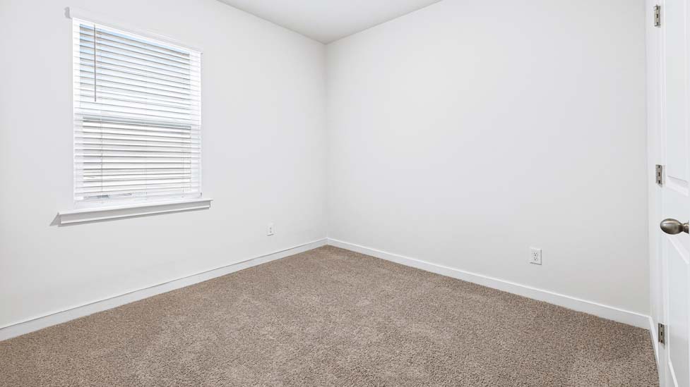 carpeted bedroom with large windows