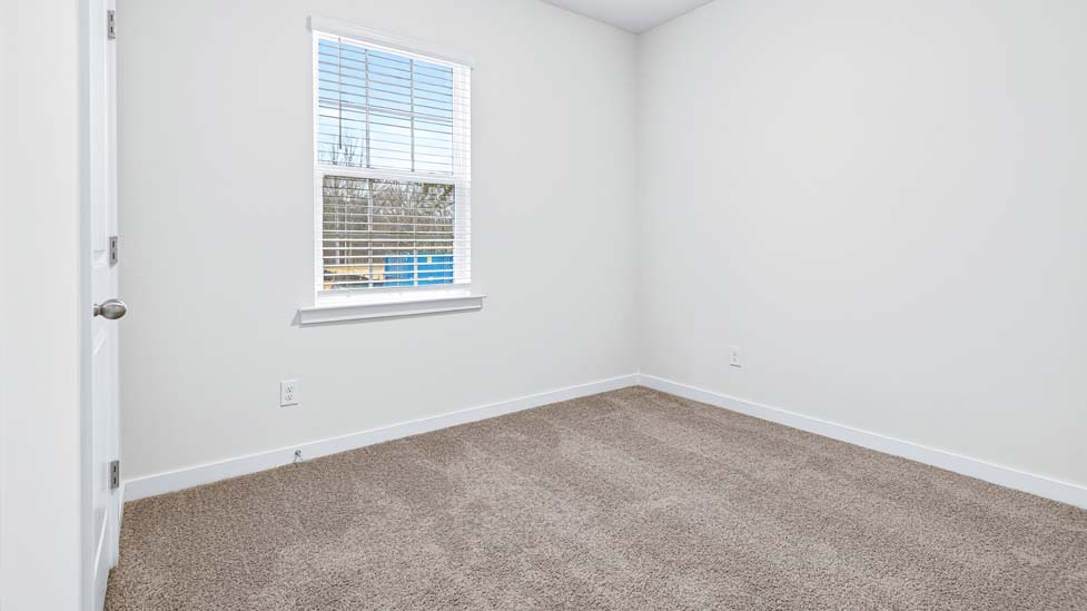 carpeted bedroom with large windows