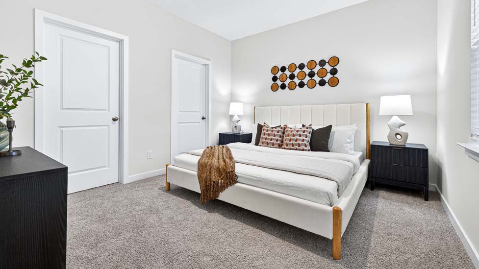 carpeted bedroom with large windows