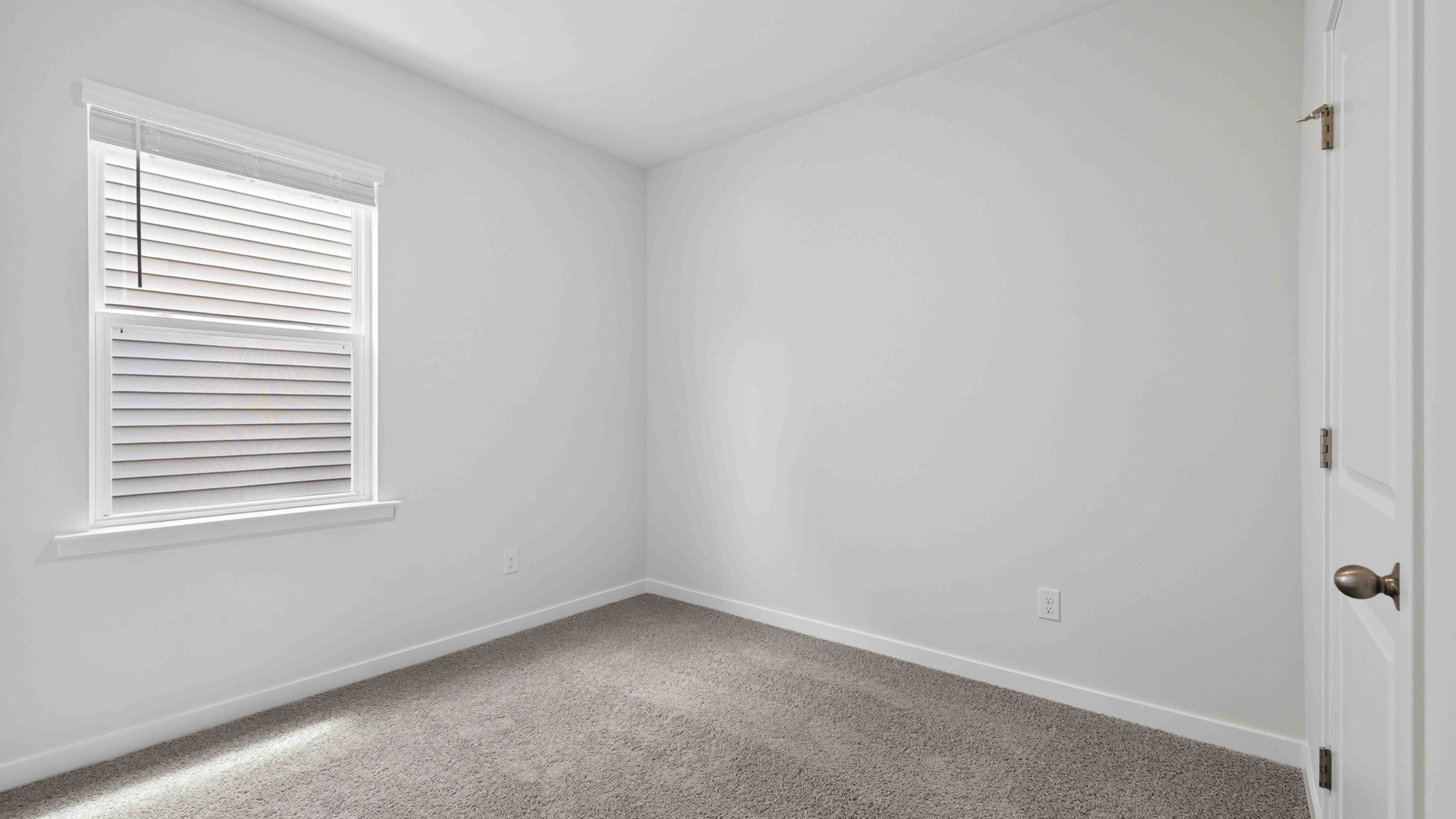 carpeted bedroom with large windows