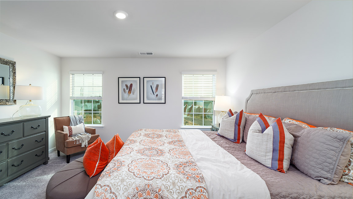 Carpeted bedroom with small windows