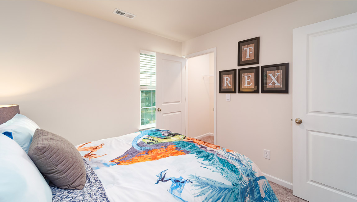 Carpeted bedroom with large window