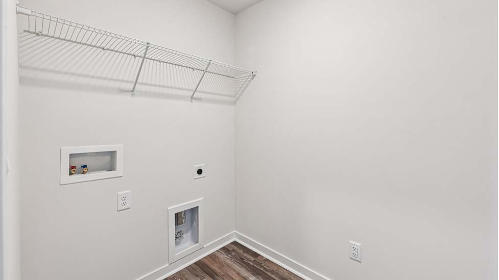 Laundry room with built in racks for hanging above machine space