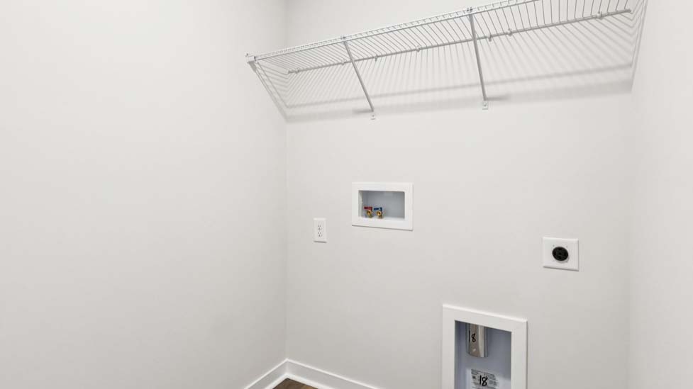 Laundry room with built in racks for hanging above machine space