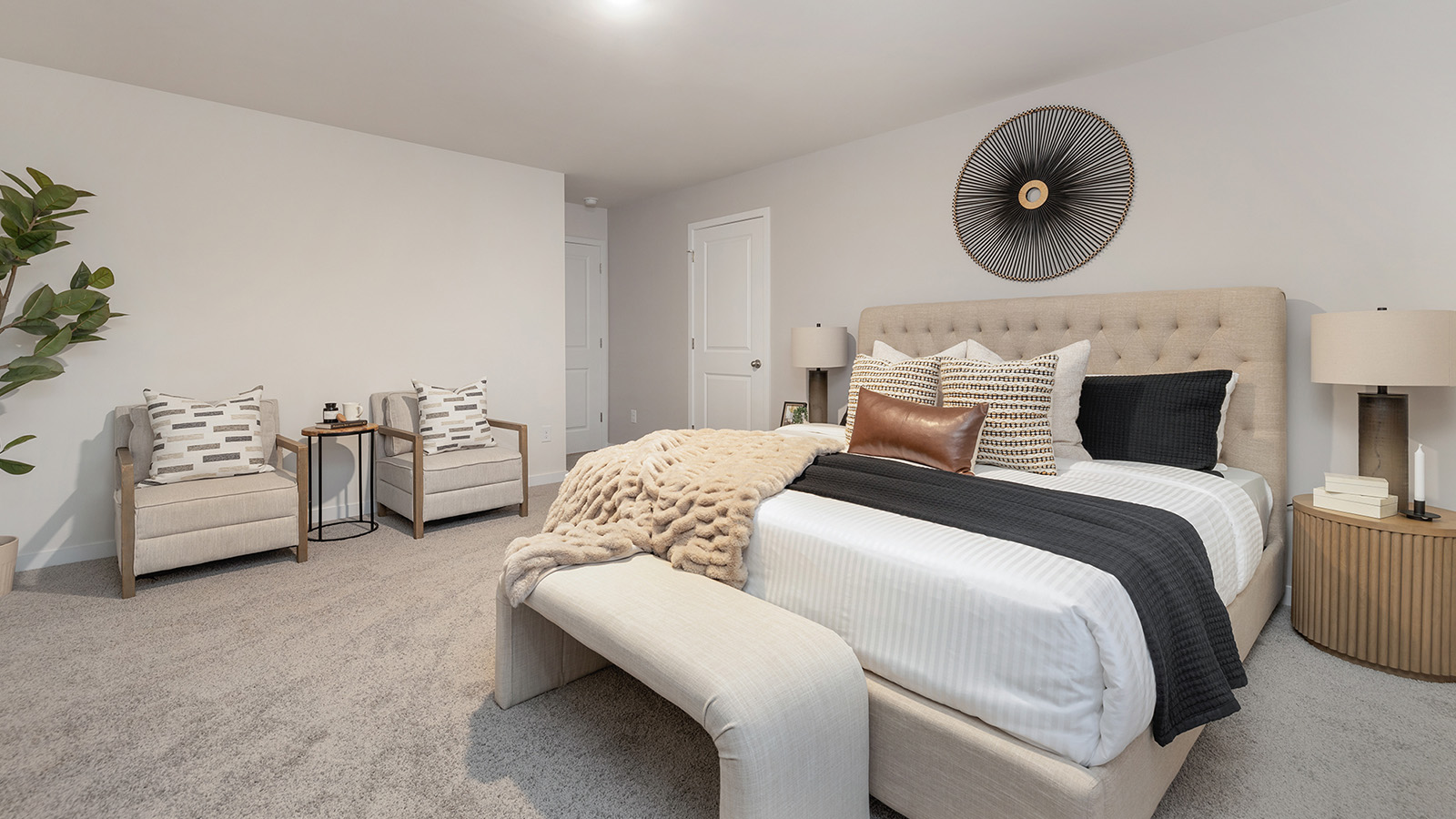 Carpeted bedroom with large window, view of bathroom door