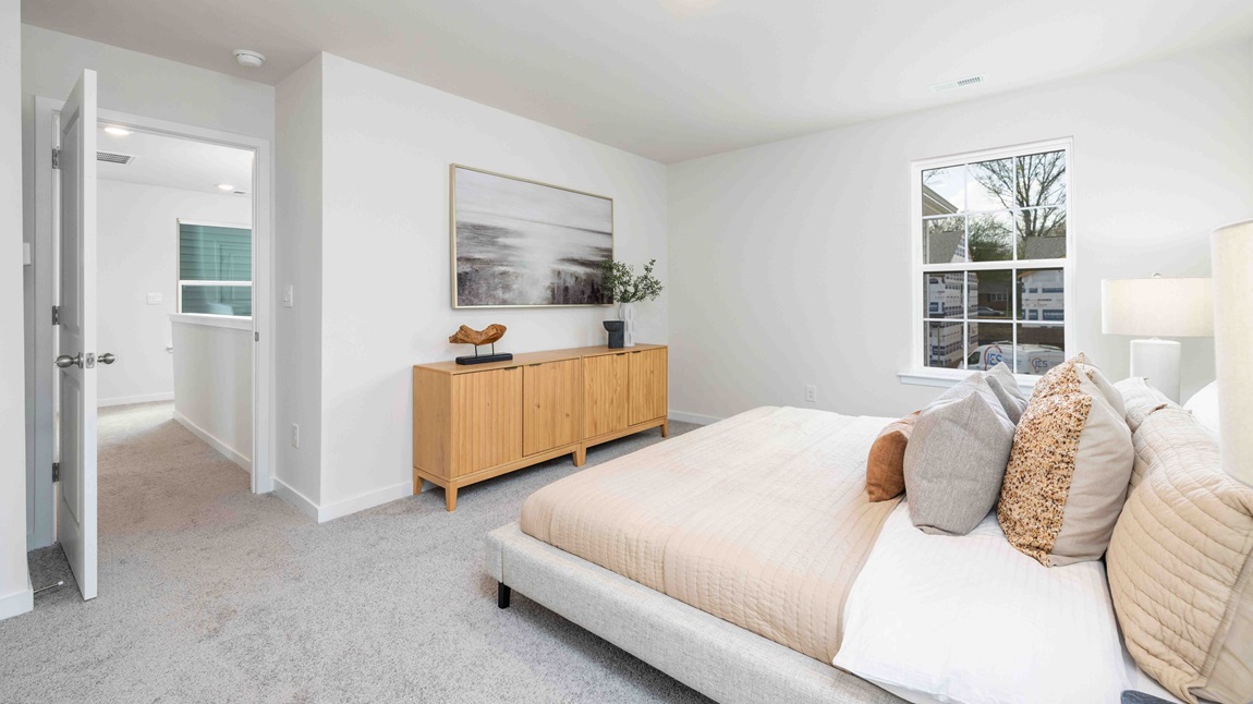 Primary bedroom, carpeted with large windows