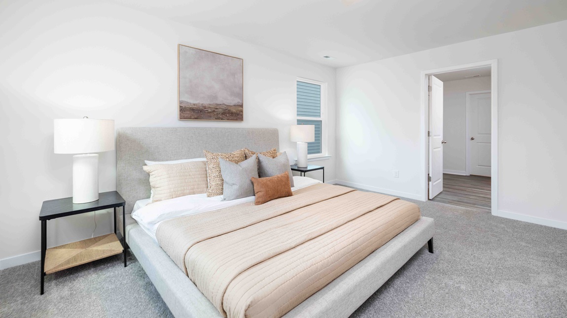 Primary bedroom, carpeted with large windows