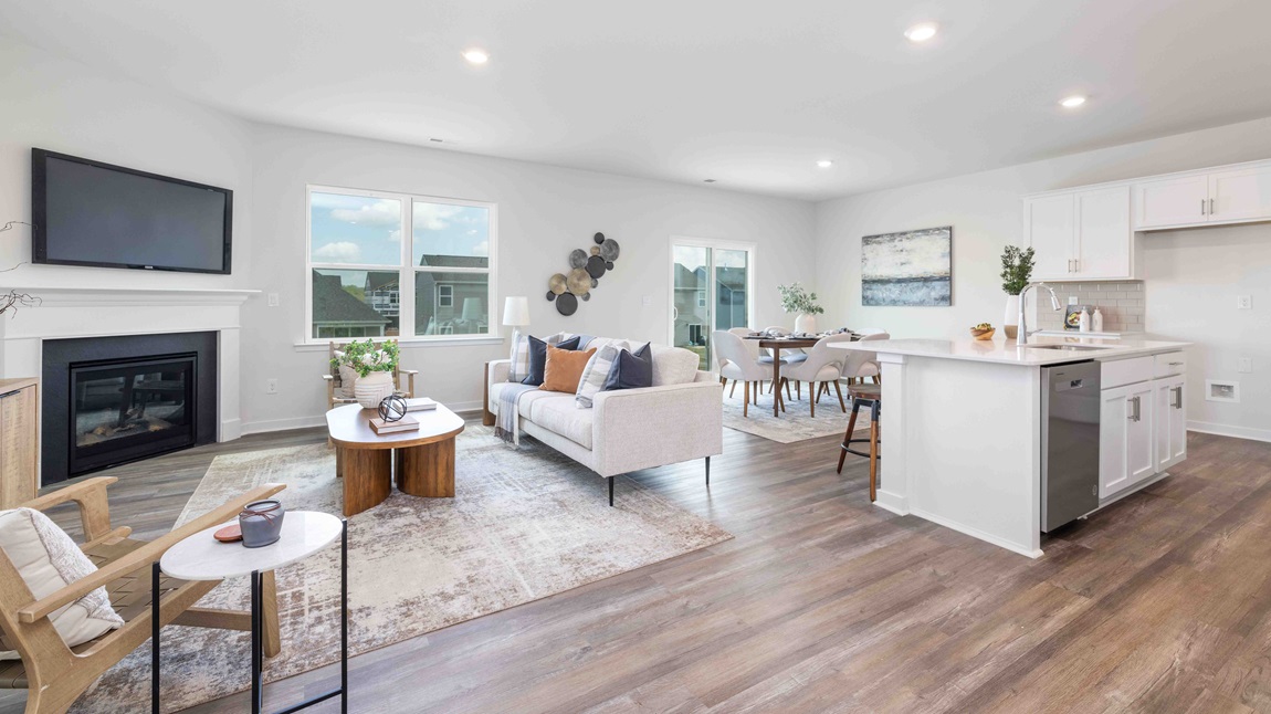 Spacious family room with large windows and fireplace