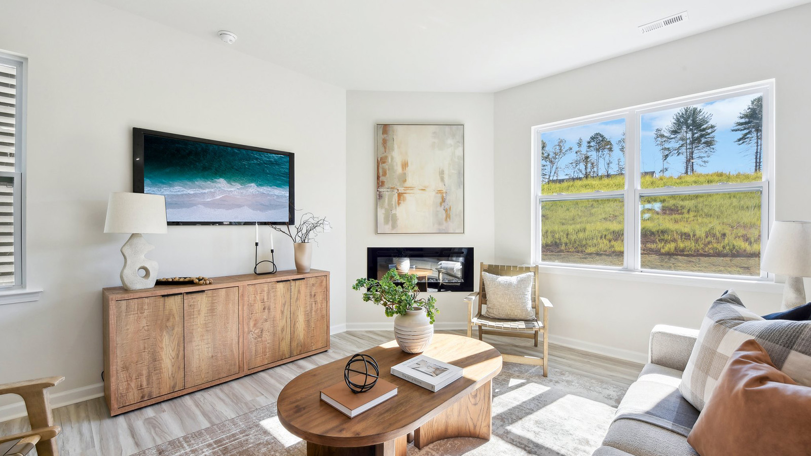 Spacious family room with large windows and fireplace