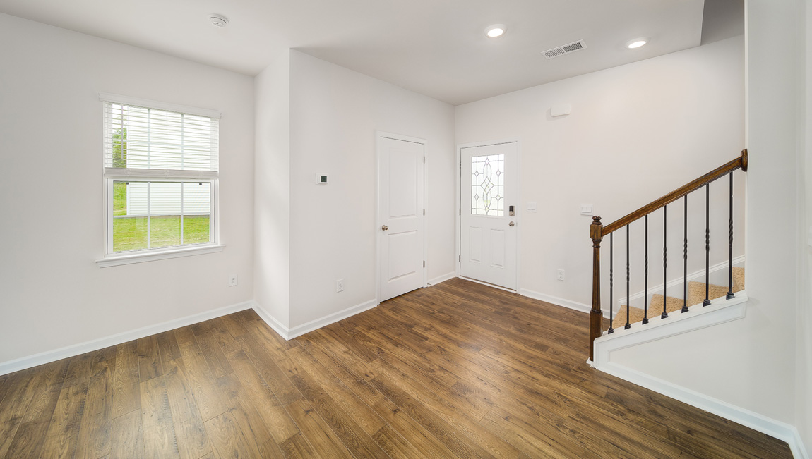 Welcoming foyer with view of front door and stairs