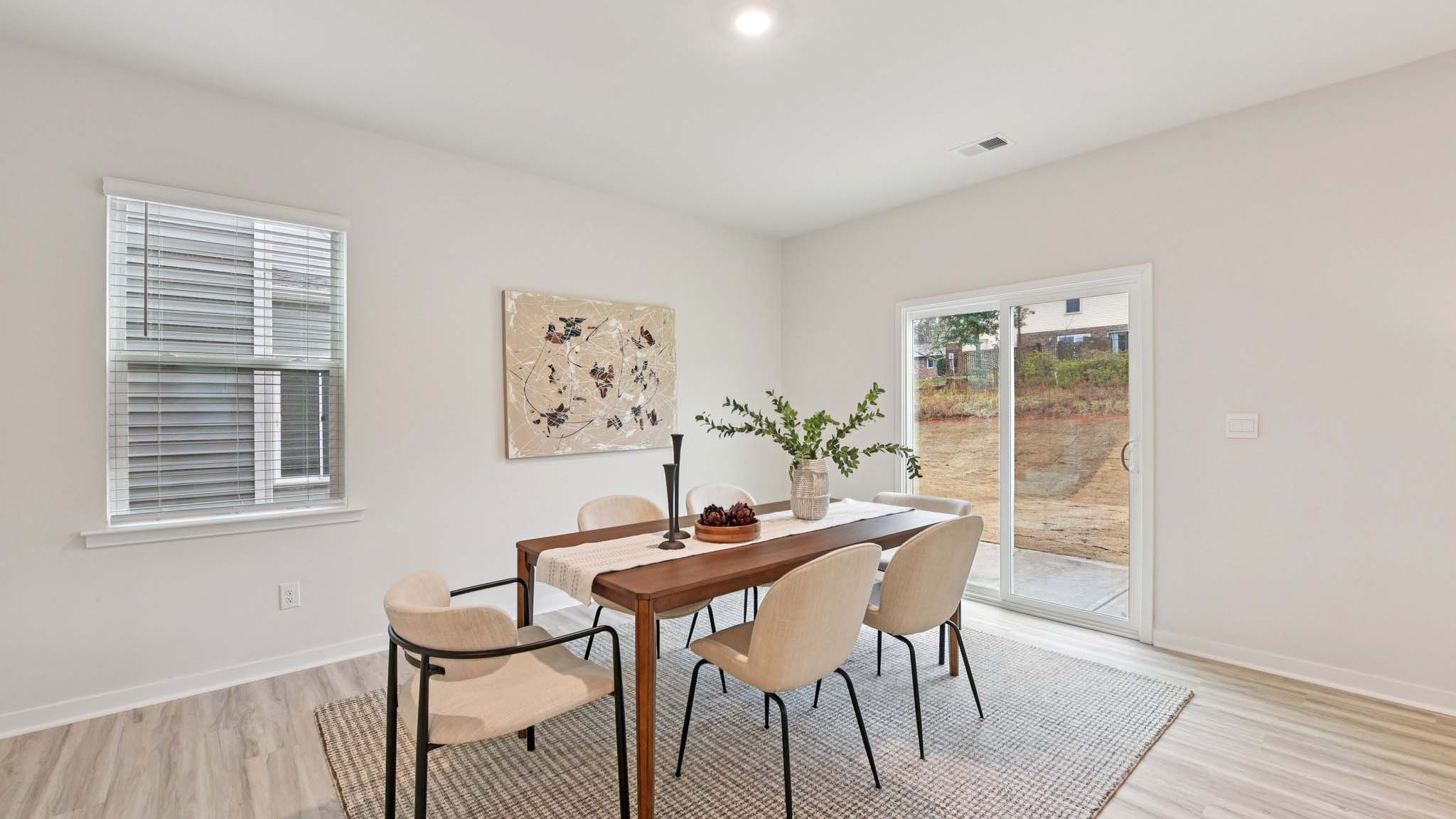 Dining area with wood floor and sliding glass door
