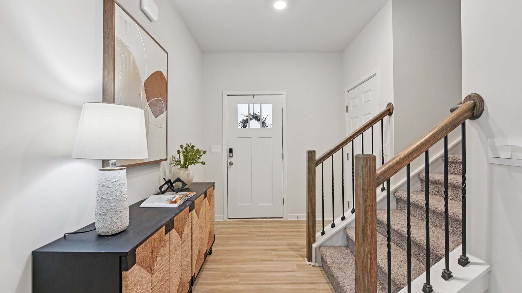 Welcoming foyer with view of front door and stairs