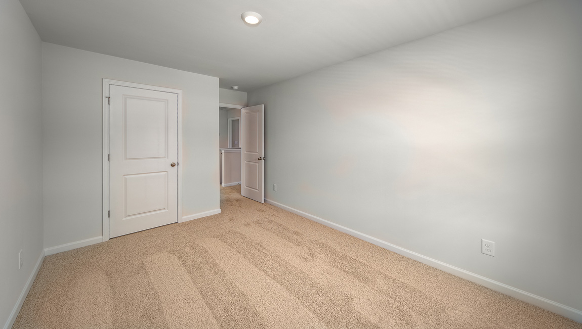 Carpeted bedroom with window