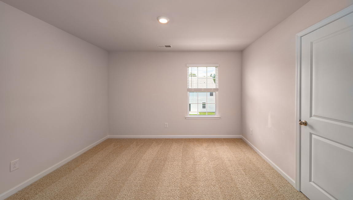 Carpeted bedroom with window