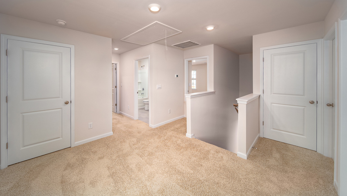 Carpeted loft space atop stairs