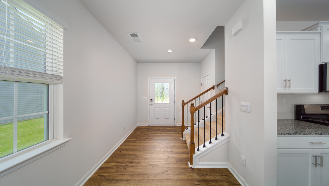 Welcoming foyer with view of front door and stairs